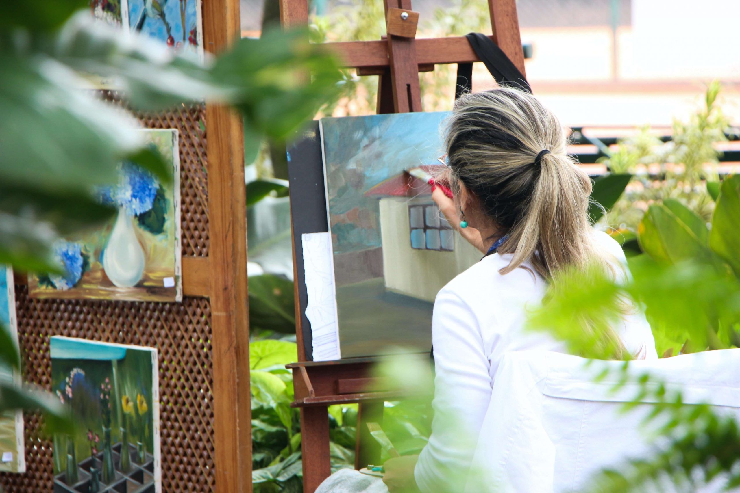 Painter painting on canvas in the outdoors